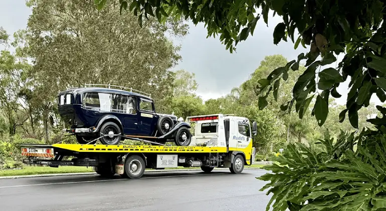 Local car transport experts securing a car for safe delivery.