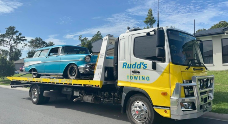 Professional tow truck safely transporting a vehicle